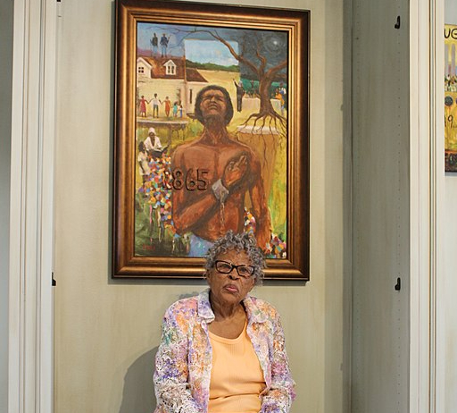 Opal Lee sitting in front of painting. Image credit: Erika Harrison, CC BY-SA 4.0 via Wikimedia Commons